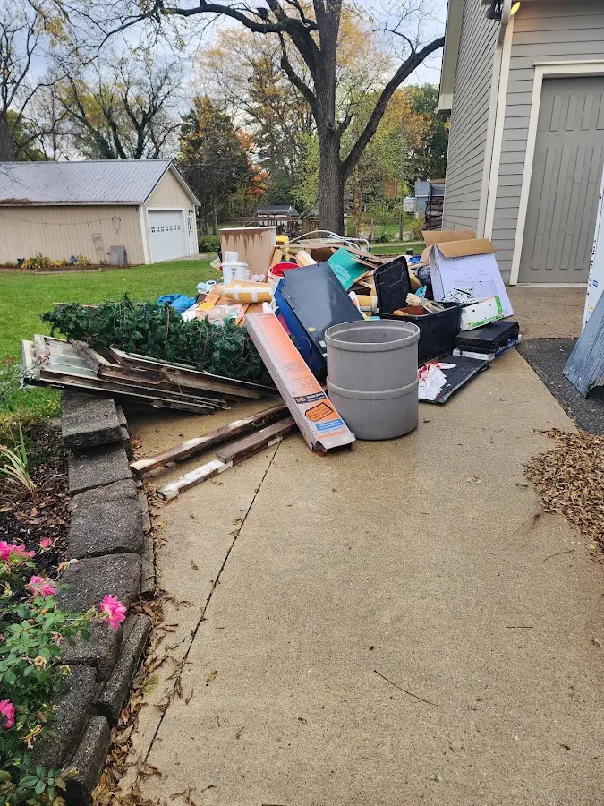 Dumpster being loaded with debris for Estate Cleanout Dumpster Rental in Honea Path